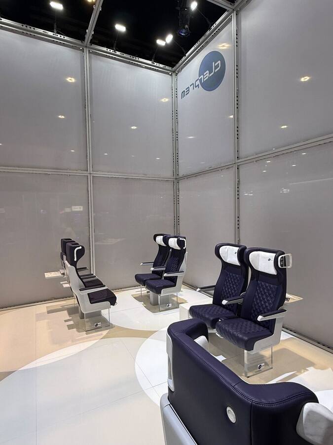 Quilted blue Clerprem railway seats with white headrests inside the APTA 2026 booth