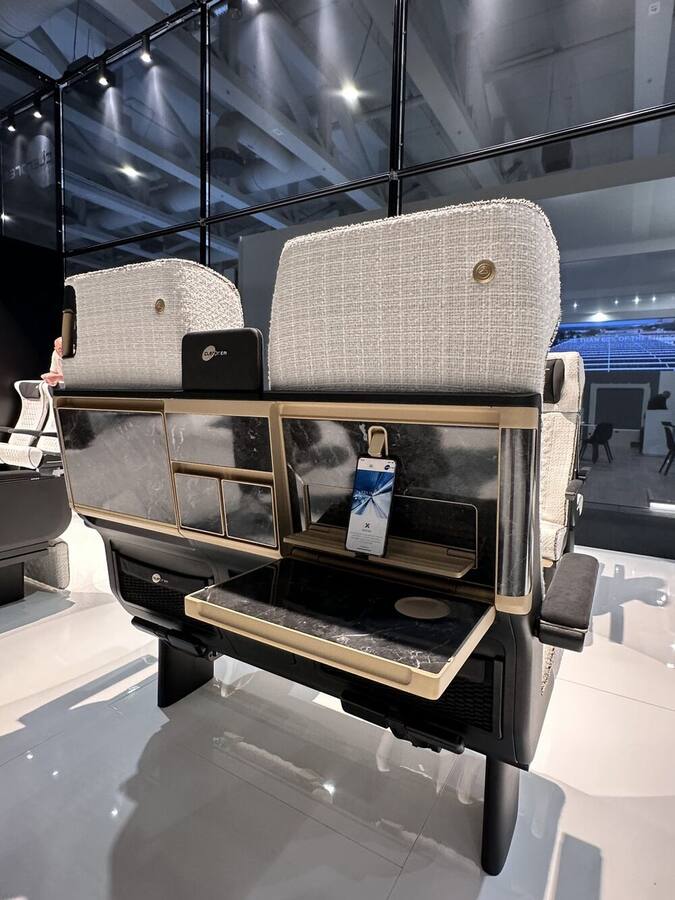 Clerprem facing-seat bay with black marble-effect table and gold finishes, InnoTrans 2026
