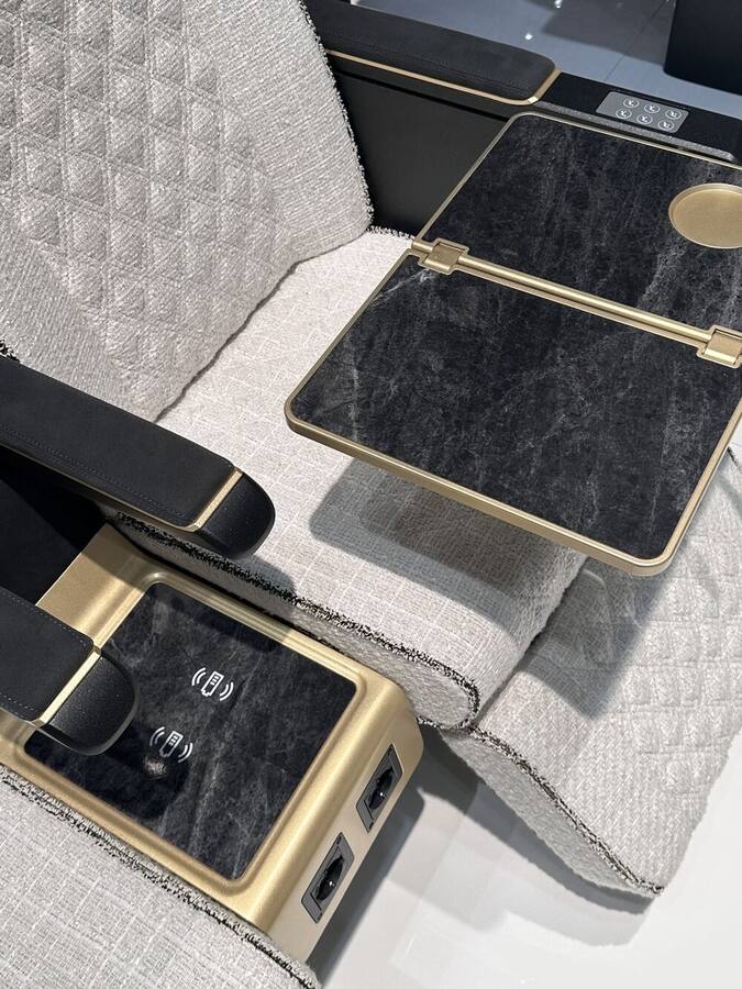 Black marble-effect table with gold finishes, wireless charging and USB ports